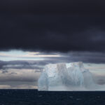 Antarctic Iceberg Dwarfs the Landscape - An Miranda